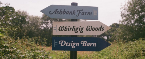 Signage at Wild Rumpus reads: Ashbank Farm, Whirligig Woods, Design Barn